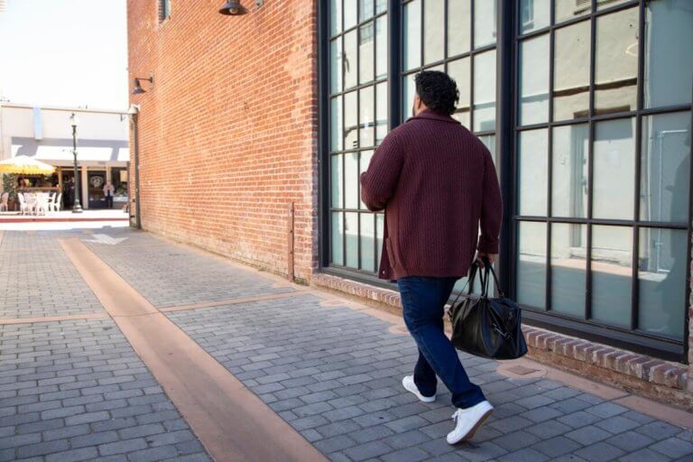 A man walking down the street in his Dillon Leather shoes