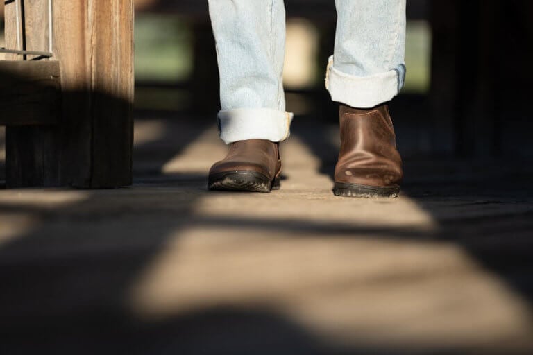 Ridgeway Chelsea boots in a beam of sunlight worn by a man in jeans